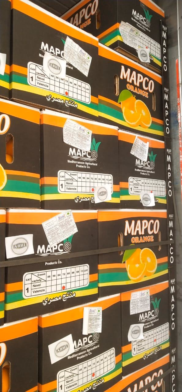 Branded orange cartons stacked in the packhouse